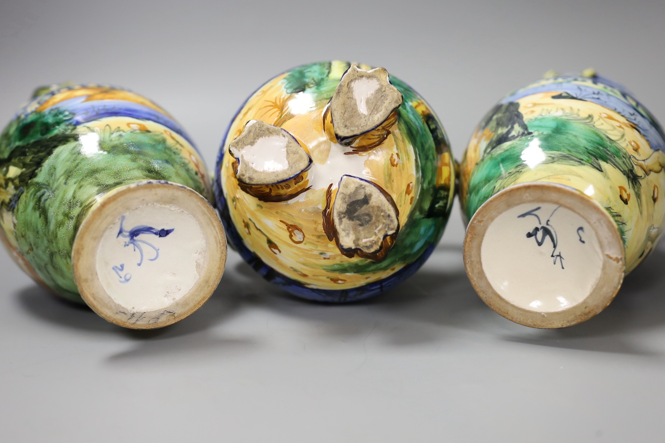 A pair of Italian maiolica vases, by Cantagalli and a similar two handled vase, cockerel marks, pair 17 cms high